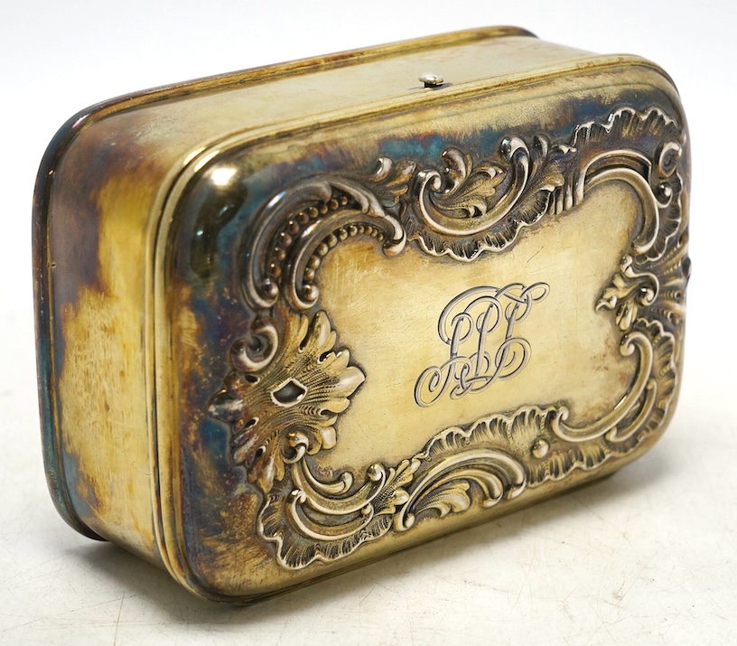An American sterling trinket box with hinged cover and foliate scroll decoration, engraved with monogram, 13.4cm, gross weight 300 grams. Condition - fair